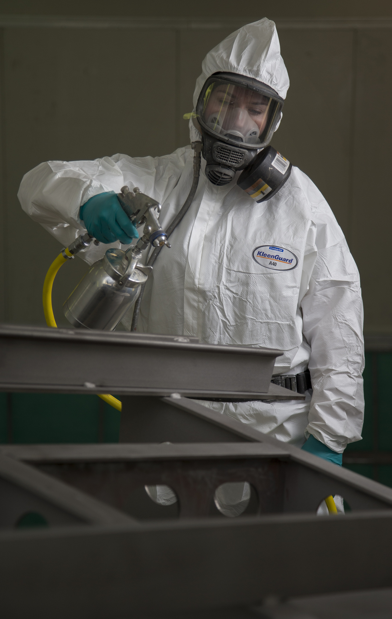    Seaman Boatswains Mate Georgia Christie prepares to paint a bilge keel in a spray booth that was transferred from the Air Force to the HMAS Stirling Fleet Support Unit's Corrosion Control section. 