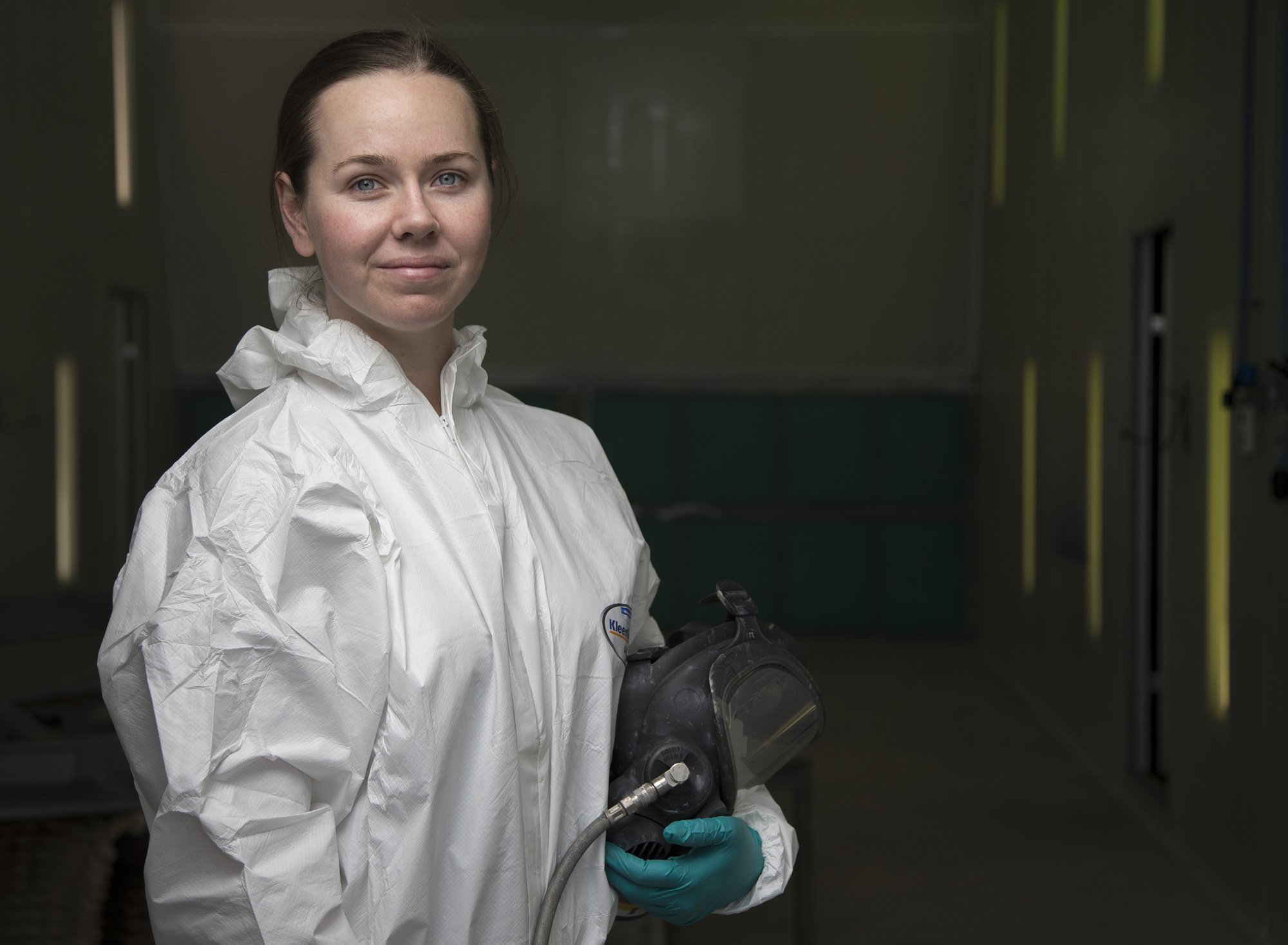 Seaman Boatswains Mate Georgia Christie in a spray booth that was transferred from the Airforce to the HMAS Stirling Fleet Support Unit's Corrosion Control section.
